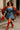 Model in denim mini dress styled with striped shawl, red boots and gold accessories