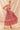Woman wearing a floral dress against a beige background