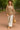 Woman in champagne floral velvet blouse with balloon sleeves walking in park