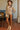 Model in champagne floral velvet blouse with balloon sleeves and slim pants