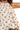 Closeup of halter neck cami top with white and geometric bow print lightweight fabric and relaxed fit