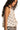 Side view of a halter neck cami top with white geometric print sleeveless design and flowy silhouette