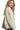 Side view of cream jacquard jacket showing sculpted silhouette and texture