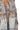 Close-up of gray denim texture with floral lace appliqué and zipper