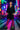 Woman in a black dress and leopard print leggings standing in a neon-lit city street.