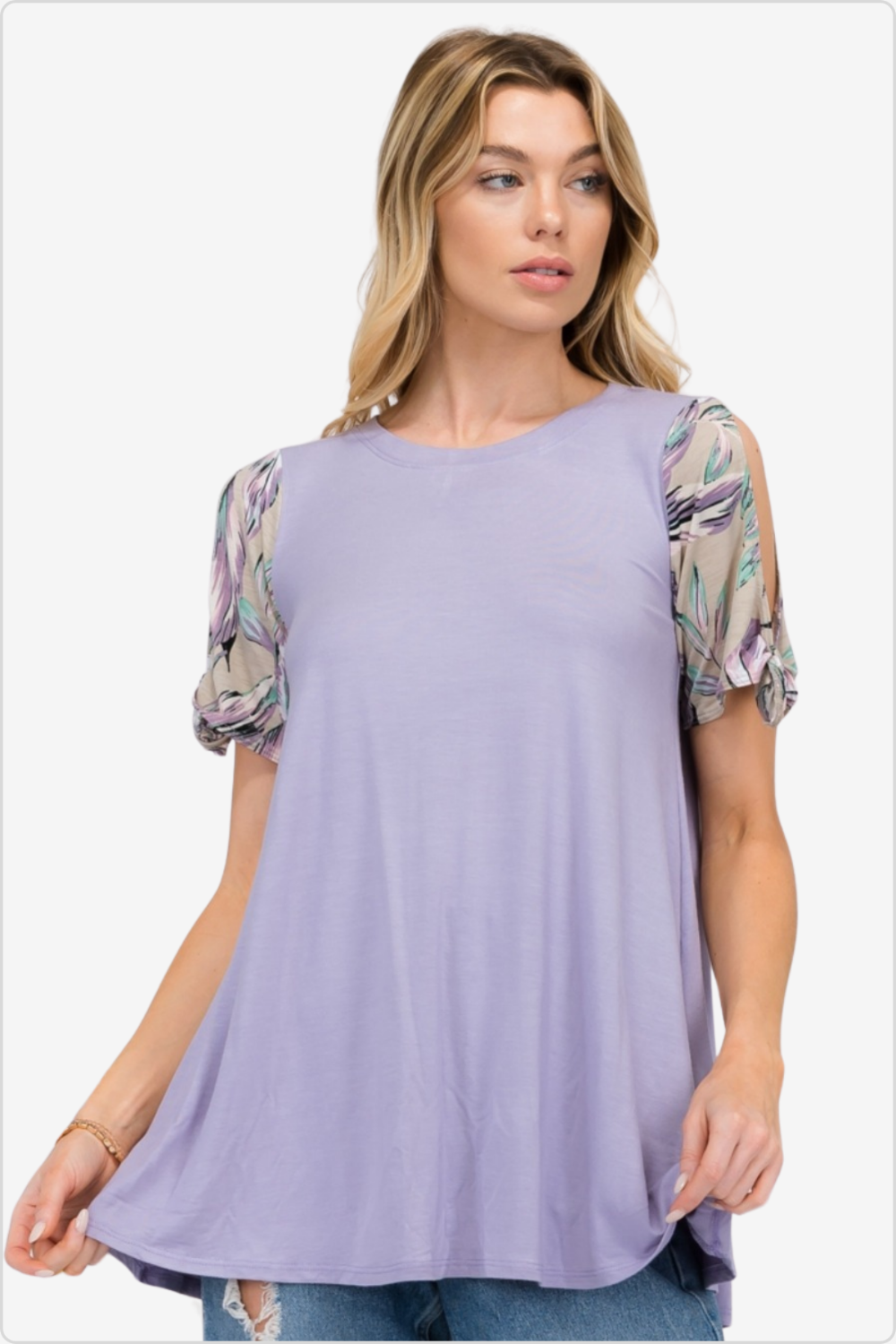 Woman sporting a soft lavender blouse with floral sleeve accents, perfect for a light summer vibe.