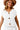 Main view of off-white knit sweater vest with large metal button and pockets