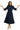 Woman wearing a navy blue dress with ruffled sleeves and hem on a white background