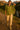 Woman in olive green shirt with jacquard hearts, cargo pants, hiking a mountain trail