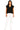 Woman wearing a black sleeveless top and white pants on a white background