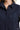 Close-up view of navy lace patch detail on cotton shirt with button closure