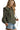 Side view of green plaid blouse highlighting puff sleeve shape and ruffle collar detail.