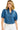 Woman wearing a blue denim jacket with puff sleeves on a white background