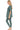 Side view showing rounded neckline and slim-fit leggings.