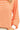 Orange and white striped long-sleeve top with a blurred background