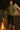 Woman by campfire wearing zip sweater jacket with high neck in Olive Green, near tent, warm fire glow