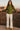 Woman wearing zip sweater jacket with high neck in Olive Green, standing by canyon railing at sunset